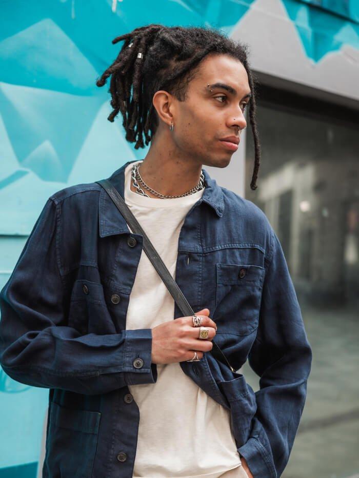 young man wearing dark blue shirt over white t-shirt